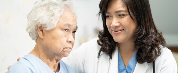 female doctor gazing at an elderly patient